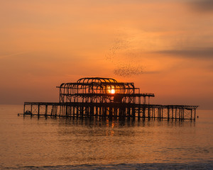 Sunset behind derelict Brighton pier