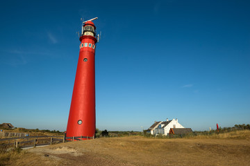 Fototapeta na wymiar The red North Tower lighthouse on the Dutch island Schiermonnikoog, The Netherlands