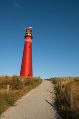 Fototapeta na wymiar The red North Tower lighthouse on the Dutch island Schiermonnikoog, The Netherlands