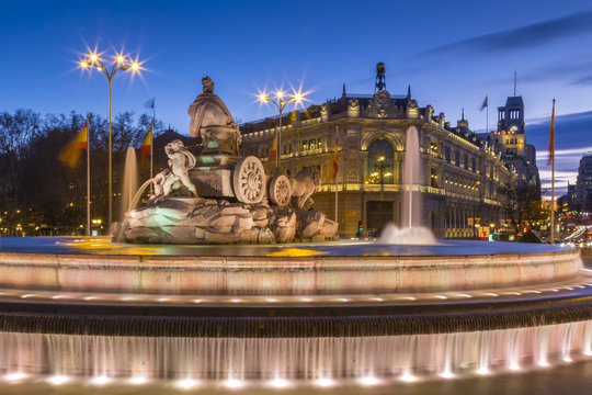 View of Cibeles Fountain in Plaza Cibeles and Calle de Alcala at dusk, Madrid, Spain