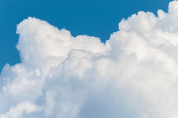 Naklejka na ściany i meble White clouds on a blue sky background.