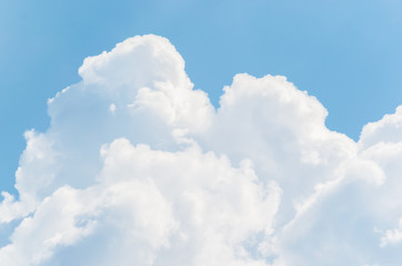 White clouds on a blue sky background.