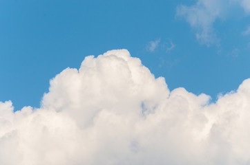 Naklejka na ściany i meble White clouds on a blue sky background.