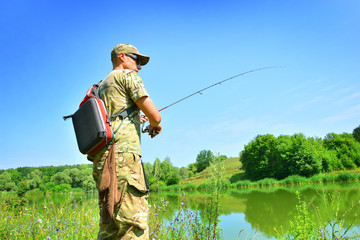 A fisherman with a spinning rod in his hands on a fishing trip