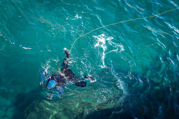 Fototapeta na wymiar Diver on the surface of bluish