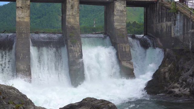 The dam of an abandoned hydroelectric power station located on a mountain river.