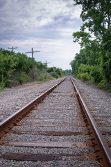 Fototapeta na wymiar Railroad Tracks and Power Lines in Portrait Mode