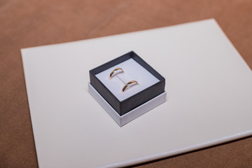Morning of the wedding day. A pair of golden rings in the box. Happy wedding day. Copy space