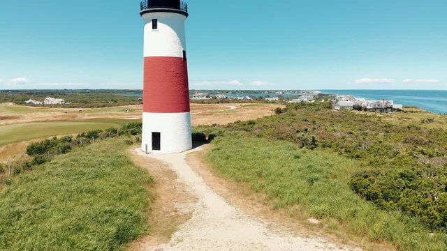 Aerial drone shot of a coastal lighthouse on Nantucket island in Massachusetts.