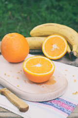 Orange juicy oranges on a wooden background. Whole and cut in half. Healthy food. Fresh organic fruits. Source of vitamin C. Copy space