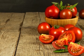 Fresh tomatoes on an old wooden table. Growing of fruits and vegetables. Healthy food. Raw vegetarian food. Sale of tomatoes.