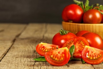Fresh tomatoes on an old wooden table. Growing of fruits and vegetables. Healthy food. Raw vegetarian food. Sale of tomatoes.