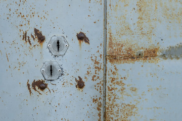 two keyholes on a metal door