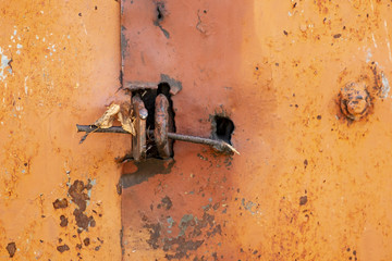 A wooden stick is inserted in the eyelet for the lock