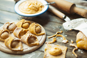 a dish of Italian cuisine. ravioli with pumpkin and cheese. cooking dinner. yellow dough