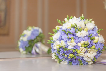 Wedding bouquet flowers bridal bouquet. beautiful white blue bouquet isolated on marble table against mirrow.colorful flowers white and blue freesia and hydrangea. Copy space