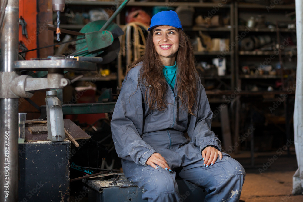 Wall mural young woman mechanic in a workshop