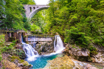 Vintgar gorge waterfall in Slovenia, Triglav national park. Pure fresh water in beautiful nature and forest. Tourist paths near waterfalls.