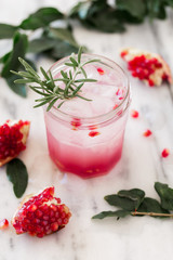  Pomegranate rosemary detox water on white marble background. 