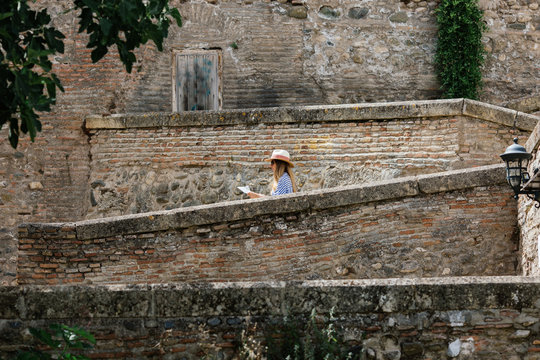 Woman doing tourism with map at Granada, Spain.