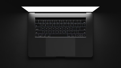 Top view of modern laptop isolated on dark background. 