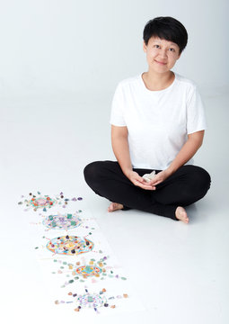 Mandala pattern with crystal and Asian women. a creator