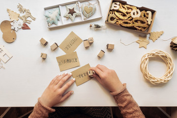 Woman Making Christmas Cards With Stamps
