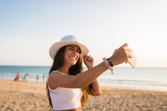 Teen girl taking a selfie at the beach