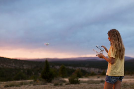 Woman flying drone at mountains