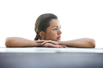 Obraz premium Beautiful woman is relaxing in an infinity pool and looking at mountain landscape, outdoors