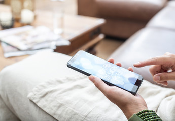 Smartphone User on Couch Mockup