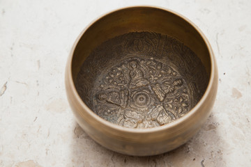 Interior of a tibetan singing bowl over a marble surface
