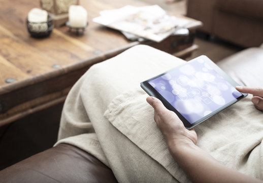Tablet User on Couch Mockup