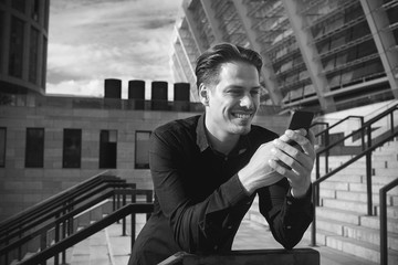 Serious business man talk on the phone in office park.