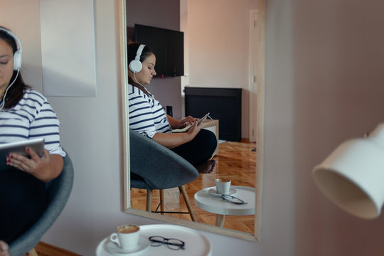 Mirror Reflection of a Woman with Headphones on her Head