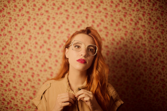 ginger woman buttoning the shirt