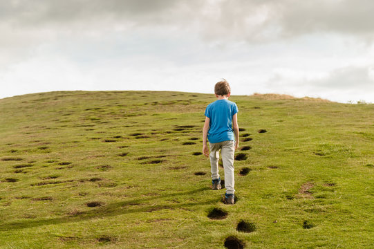 Child Walking Up A Steep Hill