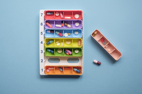 Colorful Case With Pills And Tablets On The Blue Background