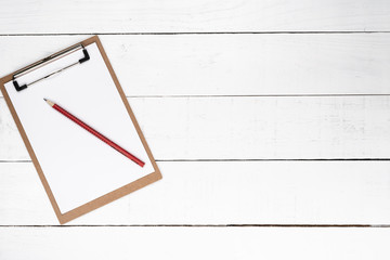 Blank notepad on red lapis over white wooden background
