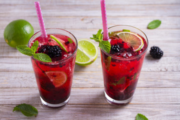 Blackberry mojito cocktail with berries, lime and mint. Summer berry cocktail