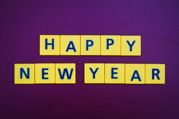 Happy New Year word formed by letter pieces