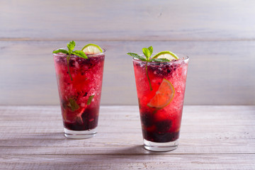 Blackberry mojito cocktail with berries, lime and mint. Summer berry cocktail