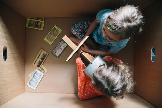 Sisters In A Cardboard Box with A Stereoscope