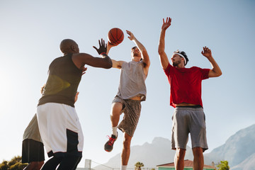 Men playing basketball - Powered by Adobe