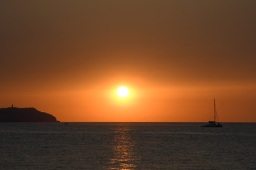 Fototapeta na wymiar The sun at sunset over the sea of Ibiza
