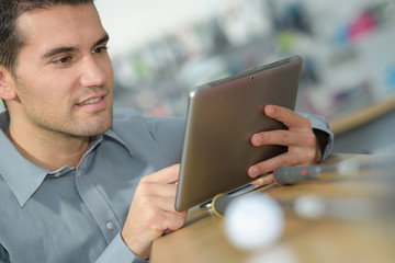 young man watching tablet and smiling