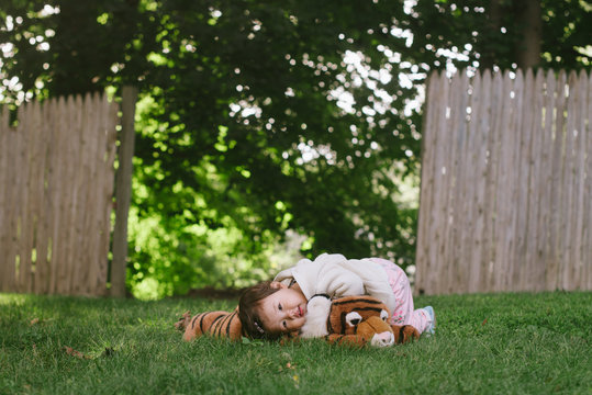 Baby Resting On Stuffed Animal Outside