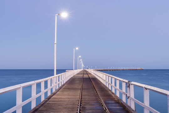 Fototapeta Long pier jetty at dawn