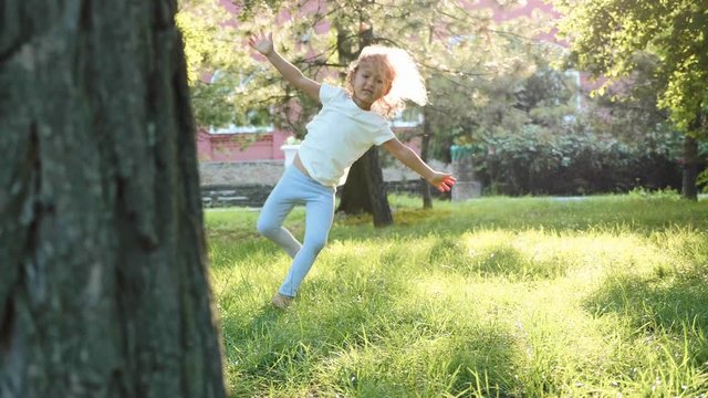 The child learns acrobatics at the park in slow motion