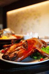Delicious, Golden Roasted BBQ Suckling pig Cantonese Style made from a piglet that turned into Chinese delicacy which its cooked skin is very crispy and the meat is tender and juicy. Selective Focus.